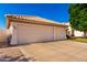 Wide driveway leading to a three-car garage, offering ample parking space and convenience for residents at 3412 E Kristal Way, Phoenix, AZ 85050