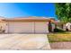 Charming single-story home with a three-car garage, tiled roof, and a well-maintained front yard at 3412 E Kristal Way, Phoenix, AZ 85050