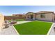 Well maintained backyard with artificial turf, fire pit and covered patio at 3415 S 75Th Dr, Phoenix, AZ 85043