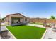 Open backyard with artificial grass, gravel and patio area at 3415 S 75Th Dr, Phoenix, AZ 85043