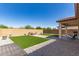 Beautiful backyard with well manicured artificial turf, patio and gravel at 3415 S 75Th Dr, Phoenix, AZ 85043