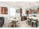 Bright eat-in kitchen featuring wood cabinets, stainless steel appliances, and a cozy breakfast nook at 3415 S 75Th Dr, Phoenix, AZ 85043