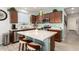 Stylish kitchen showcasing wood cabinetry, stainless steel appliances, and a large center island with bar stool seating at 3415 S 75Th Dr, Phoenix, AZ 85043