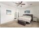 Bright primary bedroom with a ceiling fan, plush carpeting, and a serene and relaxing ambiance at 3415 S 75Th Dr, Phoenix, AZ 85043