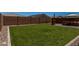Spacious backyard featuring green grass, privacy fencing, and a patio at 40380 W Jenna Ln, Maricopa, AZ 85138