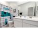 Bright bathroom with a dual-sink vanity and a shower with modern patterned curtain at 40380 W Jenna Ln, Maricopa, AZ 85138