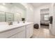 Bathroom featuring double sinks and a door to the primary bedroom at 40380 W Jenna Ln, Maricopa, AZ 85138