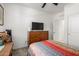 Bedroom with a ceiling fan, and a large TV atop a wooden dresser at 40380 W Jenna Ln, Maricopa, AZ 85138