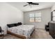 Primary bedroom featuring a ceiling fan, carpet, and window with blinds at 40380 W Jenna Ln, Maricopa, AZ 85138