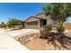 Well-kept home with a two-car garage, desert landscaping, a tiled roof, and proximity to nearby residences at 40380 W Jenna Ln, Maricopa, AZ 85138