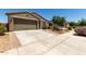 Desirable home with a two-car garage, desert landscaping, well-maintained lawn, and close proximity to neighboring homes at 40380 W Jenna Ln, Maricopa, AZ 85138