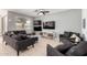 Comfortable living room featuring tile floors, recessed lights, a ceiling fan, and multiple couches for gathering at 40380 W Jenna Ln, Maricopa, AZ 85138
