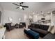 Bright living room featuring tiled floors, recessed lights, a ceiling fan, and ample seating for entertaining guests at 40380 W Jenna Ln, Maricopa, AZ 85138