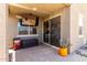 Covered patio with tiled flooring, outdoor television, and comfortable seating offers a perfect space for relaxation at 40380 W Jenna Ln, Maricopa, AZ 85138