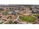 An aerial view showcases community amenities, including a pool, playgrounds, and green spaces, surrounded by residential properties at 4157 E Pinto Dr, Gilbert, AZ 85296