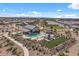 Aerial view of a community clubhouse, pool, sports field and surrounding residences at 4157 E Pinto Dr, Gilbert, AZ 85296