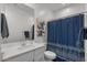 Bright bathroom featuring a vanity with sink, framed mirror and shower with blue patterned curtain at 4157 E Pinto Dr, Gilbert, AZ 85296