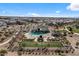 Aerial view of a community pool area with lounge chairs, playground, and well-manicured green spaces at 4157 E Pinto Dr, Gilbert, AZ 85296