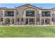Charming townhome with stucco facade, second story balcony, and well-manicured lawn at 4157 E Pinto Dr, Gilbert, AZ 85296