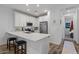 Modern kitchen with white cabinetry, stainless steel appliances, and a breakfast bar at 4157 E Pinto Dr, Gilbert, AZ 85296
