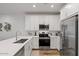 Modern kitchen featuring stainless steel appliances, white cabinets, and wood flooring at 4157 E Pinto Dr, Gilbert, AZ 85296