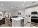 Spacious kitchen featuring stainless steel appliances, a breakfast bar, and an open floor plan at 4157 E Pinto Dr, Gilbert, AZ 85296