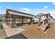 Modern playground area with a covered picnic structure, and natural wood climbing features in a well-maintained community at 4157 E Pinto Dr, Gilbert, AZ 85296