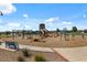 A community playground featuring swings, slides, and various play structures for children at 4157 E Pinto Dr, Gilbert, AZ 85296