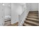 Bright staircase leading to an upper level, with carpeted steps and white railings at 4157 E Pinto Dr, Gilbert, AZ 85296