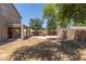 Large backyard featuring a covered patio, green grass and an outdoor cooking area at 43670 W Mcclelland Ct, Maricopa, AZ 85138