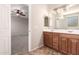 Modern bathroom featuring a double vanity, stylish mirror, and views to bedroom at 43670 W Mcclelland Ct, Maricopa, AZ 85138