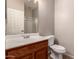 Bathroom featuring a wood vanity, white countertop, and a glass-enclosed shower, perfect for refreshing at 43670 W Mcclelland Ct, Maricopa, AZ 85138