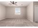 Bright bedroom features a large window and plush carpeting, creating a cozy atmosphere at 43670 W Mcclelland Ct, Maricopa, AZ 85138