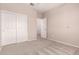 Bedroom with carpet flooring, double closet and an open door, ideal for relaxation and storage at 43670 W Mcclelland Ct, Maricopa, AZ 85138