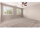 Bright bedroom with modern plantation shutters, neutral walls and plush carpet flooring at 43670 W Mcclelland Ct, Maricopa, AZ 85138