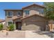 Two-story home featuring a tile roof, desert landscaping, and a two-car garage at 43670 W Mcclelland Ct, Maricopa, AZ 85138