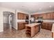 Eat-in kitchen boasts generous cabinetry, stainless steel appliances, and a convenient island for meal preparation at 43670 W Mcclelland Ct, Maricopa, AZ 85138