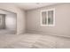 Spacious living area featuring neutral tones, plush carpeting, and plenty of natural light at 43670 W Mcclelland Ct, Maricopa, AZ 85138