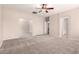Bright living area featuring neutral tones, plush carpeting, and open doorways at 43670 W Mcclelland Ct, Maricopa, AZ 85138