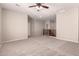 Spacious loft area with neutral carpet and ceiling fan providing a versatile living space at 43670 W Mcclelland Ct, Maricopa, AZ 85138