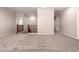 Open loft featuring neutral carpeting and stairs with wood railing overlooking the lower level at 43670 W Mcclelland Ct, Maricopa, AZ 85138