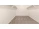 Spacious walk-in closet featuring neutral walls, carpet, and shelving at 43670 W Mcclelland Ct, Maricopa, AZ 85138
