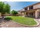 Backyard with well-manicured lawn and covered patio at 4507 E Lantern Pl, Gilbert, AZ 85297