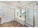 Bathroom featuring a separate shower and tub, complete with a window and tile flooring at 4507 E Lantern Pl, Gilbert, AZ 85297