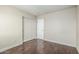 Bright bedroom features dark wood floors, closet, and white trim at 4507 E Lantern Pl, Gilbert, AZ 85297