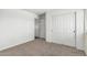 Bedroom showcasing a neutral color scheme, plush carpeting, and closet with sliding doors at 4507 E Lantern Pl, Gilbert, AZ 85297
