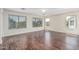 Spacious bonus room with plenty of natural light, wood flooring, and multiple large windows at 4507 E Lantern Pl, Gilbert, AZ 85297