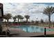 Relaxing community pool area surrounded by palm trees and comfortable lounge chairs for resident enjoyment at 4507 E Lantern Pl, Gilbert, AZ 85297