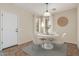 Bright dining area features tile floors, a round table, and natural light from a window with white curtains at 4507 E Lantern Pl, Gilbert, AZ 85297