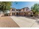 Two-story home with three-car garage, neutral stucco exterior and spacious driveway at 4507 E Lantern Pl, Gilbert, AZ 85297